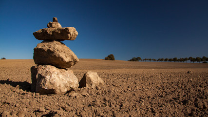a pile of stones on the field in the sunshine © Uwe