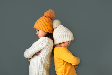 offended Caucasian children girls in knitted hats