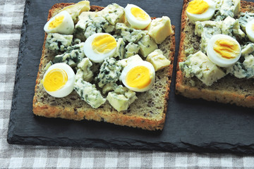 Keto diet. Toast with blue cheese and quail eggs. Keto toasts. Healthy snack.