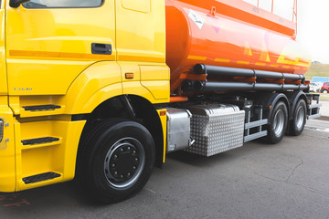 A heavy yellow-orange fuel tanker designed to carry fuel.