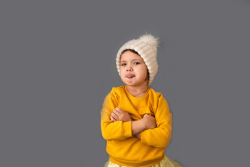 Funny caucasian child in knitted hat with pompom