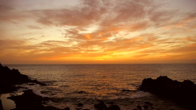 Time lapse of an amazing winter red sunset at the sea in paradise