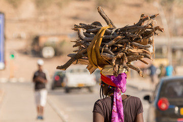  African woman carrying goods on the head.