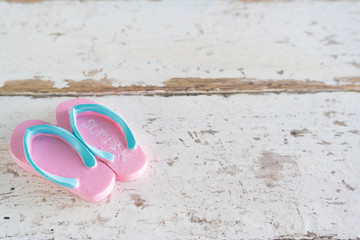 Summer time vacation concept. Beach Accessories shoe on white vintage wooden background.