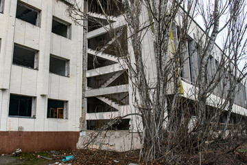 Abandoned ghost town Prypiat. Overgrown trees and collapsing buildings in Chornobyl exclusion zone....