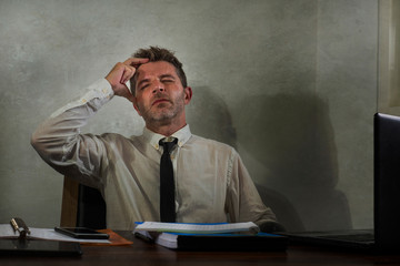 desperate financial executive man in stress - corporate business lifestyle portrait of stressed and overwhelmed businessman working frustrated and anxious having depression