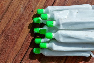 Chuna, Paan Wala Chuna, Limestone,Limestone Powder, limestone powder tube in plastic jar close up view,chuna on wooden table,lime powder Tube,