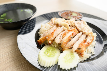 Chicken rice on a black plate