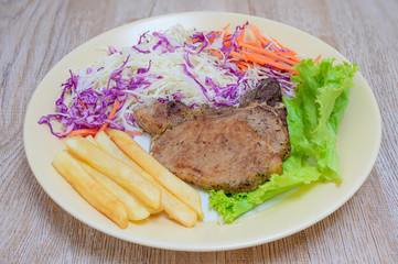 Grilled steak with french fries on the plate