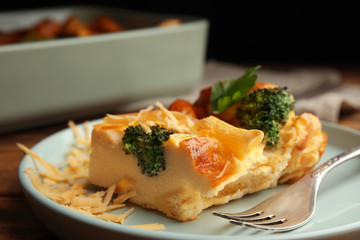 Tasty broccoli casserole with cheese on plate, closeup