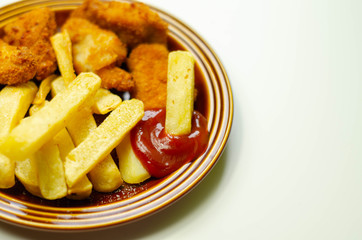 Chicken breast chunks, coated in breadcrumbs with potato chips and ketchup