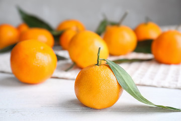 Fresh ripe tangerine on white wooden table