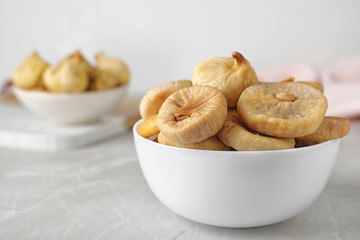 Tasty dried figs on light grey table