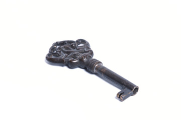 Closeup of an old key, showing heavy usage marks. Isolated on white.