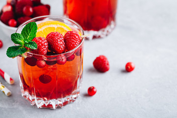 Raspberry Cranberry Sangria Punch or Mojito in glass with orange slices and mint
