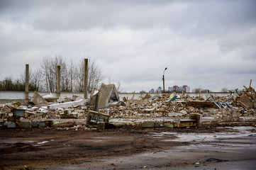 The concept of trash environmental disaster. Photo of a landfill on a street in a city on a cloudy day.