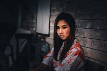 A women sitting at abandonat with Halloween concept.