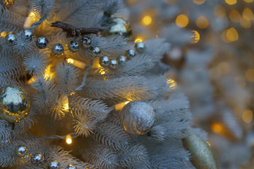 Photography of decoration of  artificial Christmas tree. Bright balls in focus. Concepts of holidays, New Year's Eve, good mood and vacations.