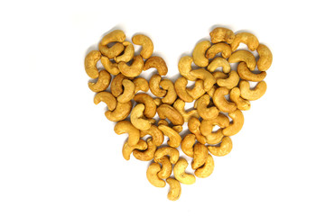 Obraz premium Cashew nut group heart pattern isolated white background - healthy nutrients food for heart concept 