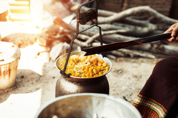 Boiling yellow silkworm cocoons by boiler to make silk thread.
