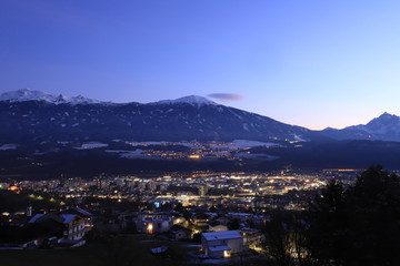 Fototapeta na wymiar Small Tyrolean town. Snowy Alps in the background