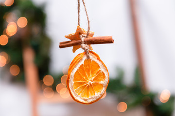 Hanging Christmas decoration of dried oranges, tangerine and cinnamon stars. holiday concept....