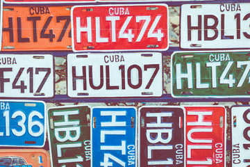 HAVANA, CUBA - DECEMBER 18, 2019:  Traditional handcrafted vehicle registration plates like souvenirs for sale in La Havana, Cuba.
