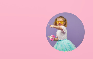 Adorable smiling child with spring flower bouquet and greating card in circle hole in the wall. Little toddler girl holding yellow tulips as gift for mother. 8 march or mother day concept