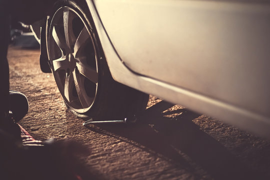 Flat Car Tire  With Tire Maintenance, Damaged Car Tyre At Night.