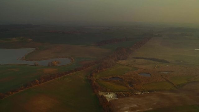 Cinematic, dreamy Polish landscape at sunset. Warmia Masuria wetlands. Aerial drone footage.