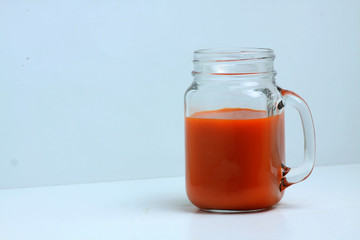 glass mug of carrot juice isolated on white background