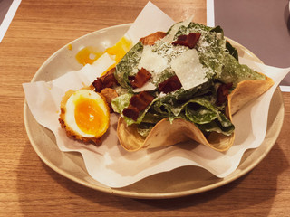 Caesar salad with bacon and boiled yolk egg