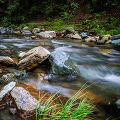 Naklejka na ściany i meble Smooth water and rocks in Sonoma Creek at Sugarloaf Ridge State park in Kenwood California