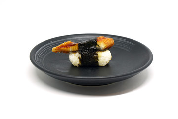 Japanese Food -  Unagi sushi on black plate isolated on white background - aerial view