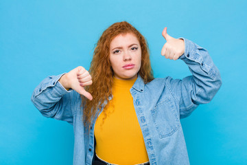 young red head woman feeling confused, clueless and unsure, weighting the good and bad in different...