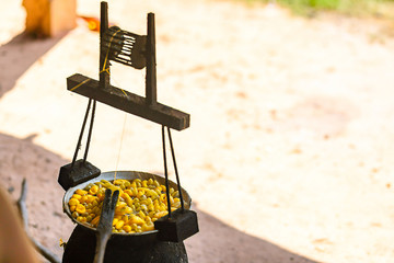 Boiling yellow silkworm cocoons by boiler to make silk thread.