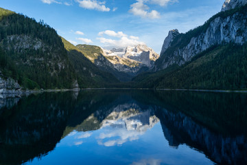 Fototapeta na wymiar Lake Gosausee is one of the most beautiful places in Austrian Alps, The scenery around is just breathtaking, you can see beautiful mountains around and also the Dachstein glacier. Tourism in Austria