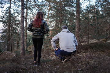 European Family Father and teenager Girl in Forest Pointing on something Watching and Looking.