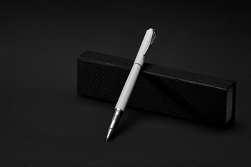 White ballpoint pen for writing text, using a rotating ball, ink is transferred to paper.