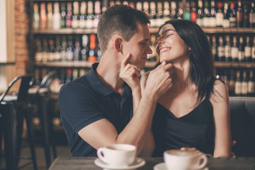 Loving couple hugging in the cafe.