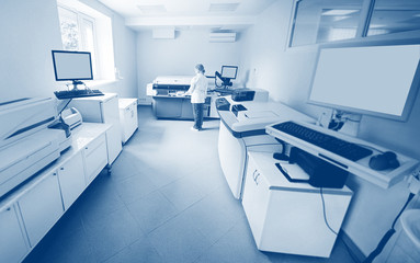  scientist near the analyzer in a medical microbiological laboratory