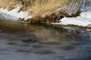 winter landscape in the forest with snow and blue sky and river