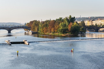 Strelecky Island with weir on Vltava river near National Theatre and the Charles Bridge, Prague,...