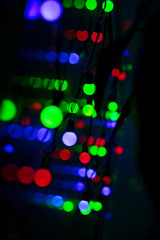 Multi-colored glare from garlands in the form of abstraction in the dark