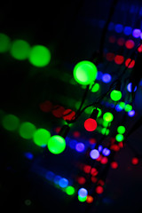 Multi-colored glare from garlands in the form of abstraction in the dark
