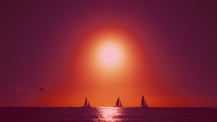 The calm horizon of the sea with scarlet sails against the backdrop of the setting sun. Beautiful...