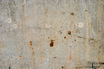 Smooth concrete wall with dirt.