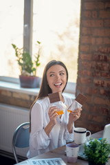 Joyful pretty woman wanting to eat chocolate