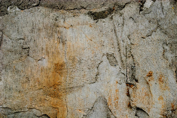 Concrete wall with cracks and traces of rust.