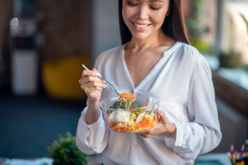 Nice happy fit woman eating healthy food